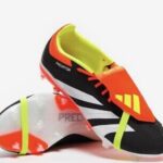 Predator black & orange academy football boots